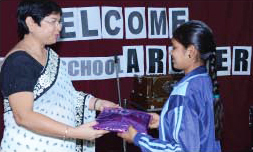 Ms. Pushpy Dutt, Principal GIIS Surat felicitating a student Mahatma Gandhi Global Indian Eklavya School