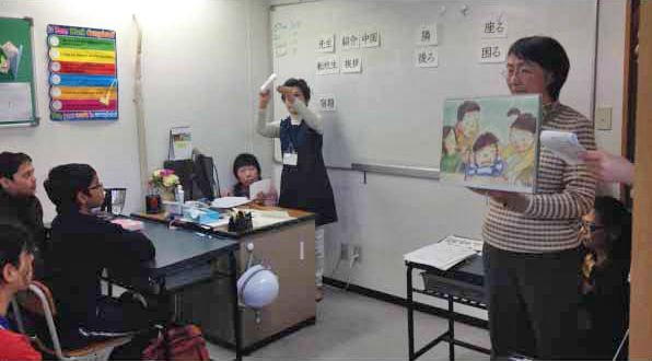 The volunteer teachers teaching Japanese Kanjis through stories