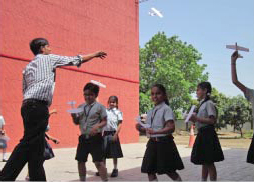 Robotics instructor showing the students how to fly their planes at GIIS Surat